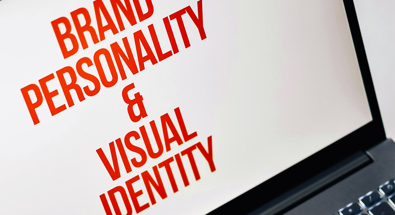 A white computer screen with letters in all uppercase, bold, and red, read: Brand personality & Visual Identity